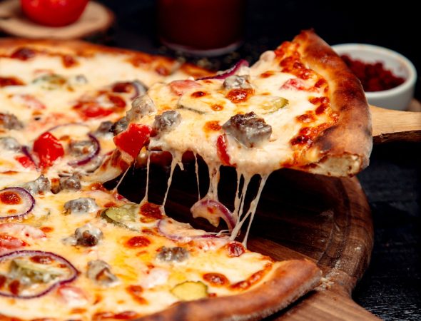a slice of crispy pizza with meat and cheese